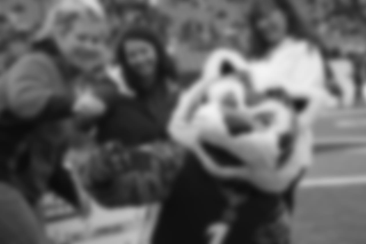 Bengals mascot Who Dey takes a selfie with fans during a check presentation prior to the game against the Oakland Raiders.