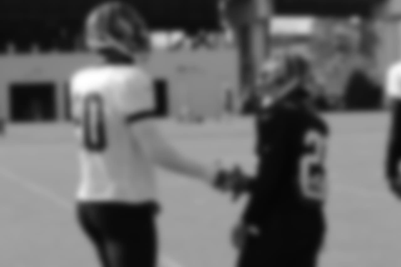 Michael Johnson and Giovanni Bernard greet each other at Wednesday's practice.