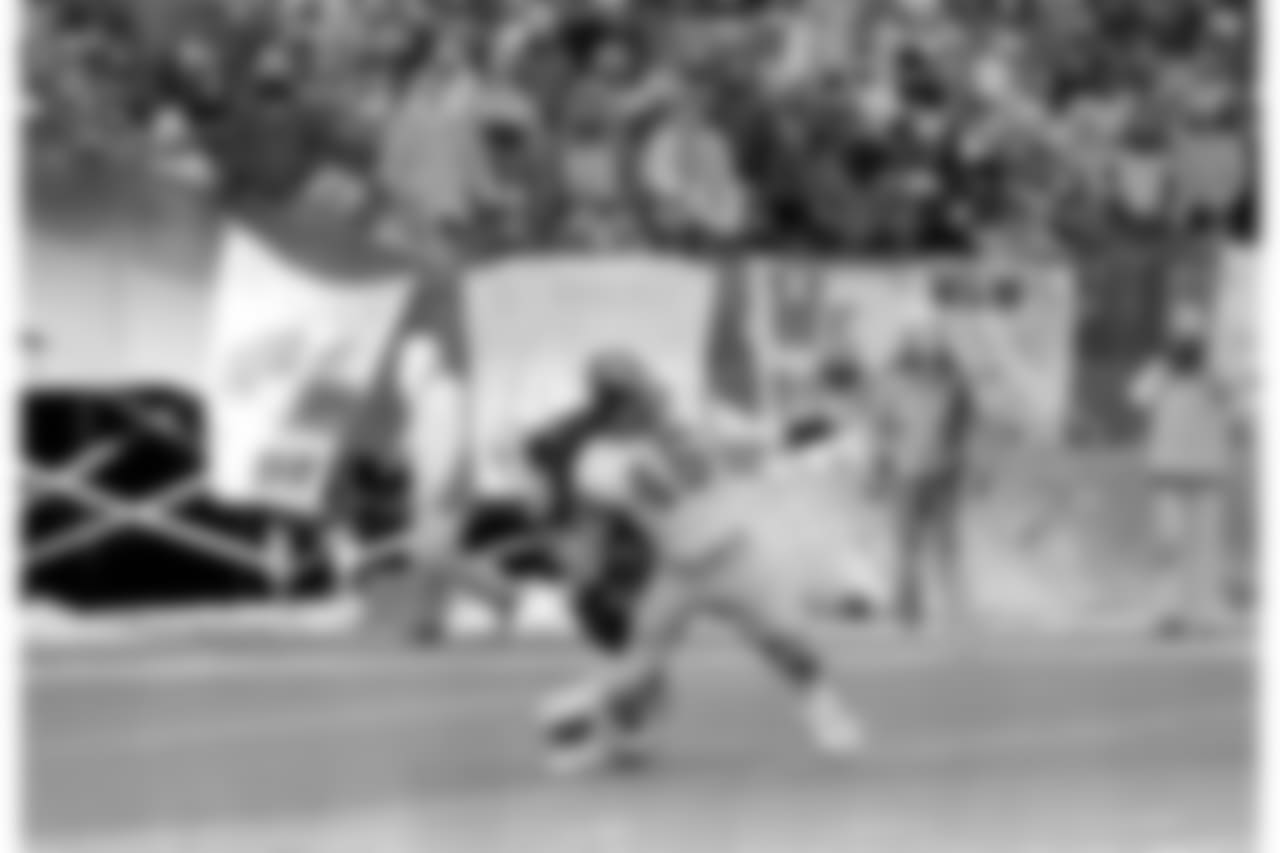 San Diego Chargers running back Chuck Muncie (46) reaches for a pass from quarterback Dan Fouts during the AFC championship game against the Cincinnati Bengals in Cincinnati on Jan. 11, 1982. Bengals defensive player Mike Fuller helps break up the play. The Bengals won 27-7. (AP Photo)