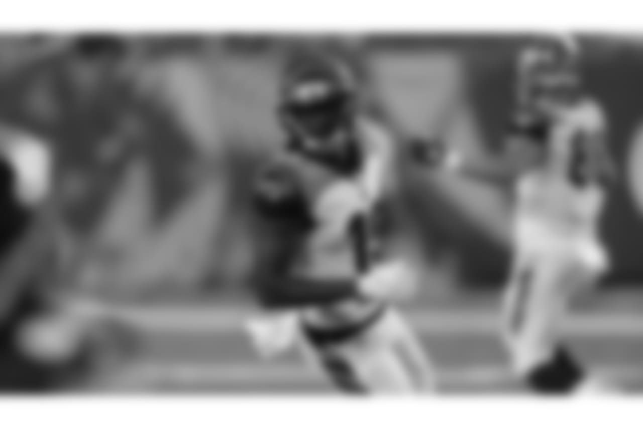 Auden Tate finishes running a route during an exhibition game against the Chicago Bears.