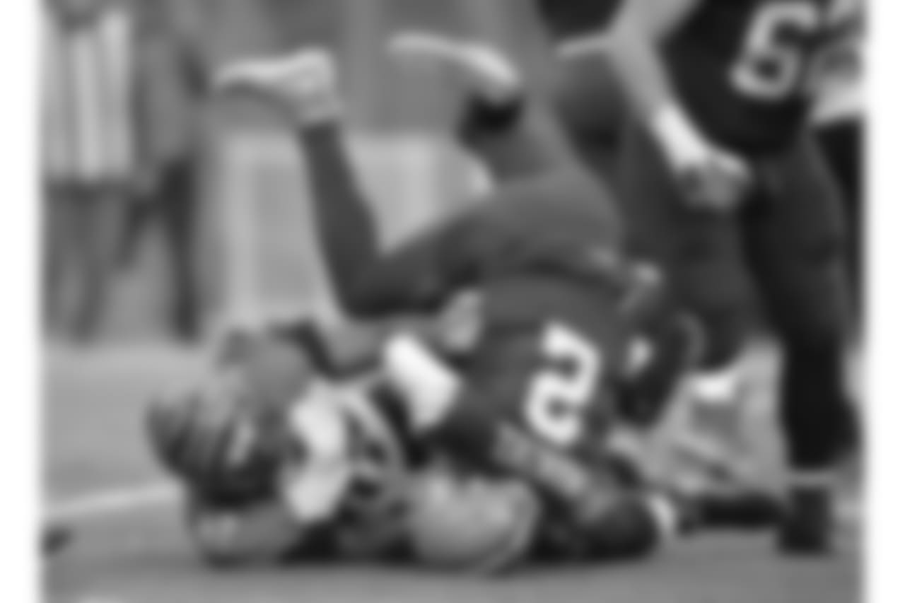 Cincinnati Bengals defensive tackle Geno Atkins (97) sacks Cleveland Browns quarterback Johnny Manziel (2) in the third quarter of an NFL football game, in Cleveland.