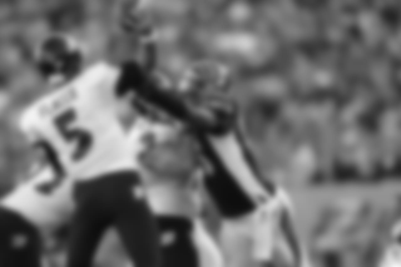 Carlos Dunlap hits Joe Flacco as he throws during a 2014 contest against Baltimore.