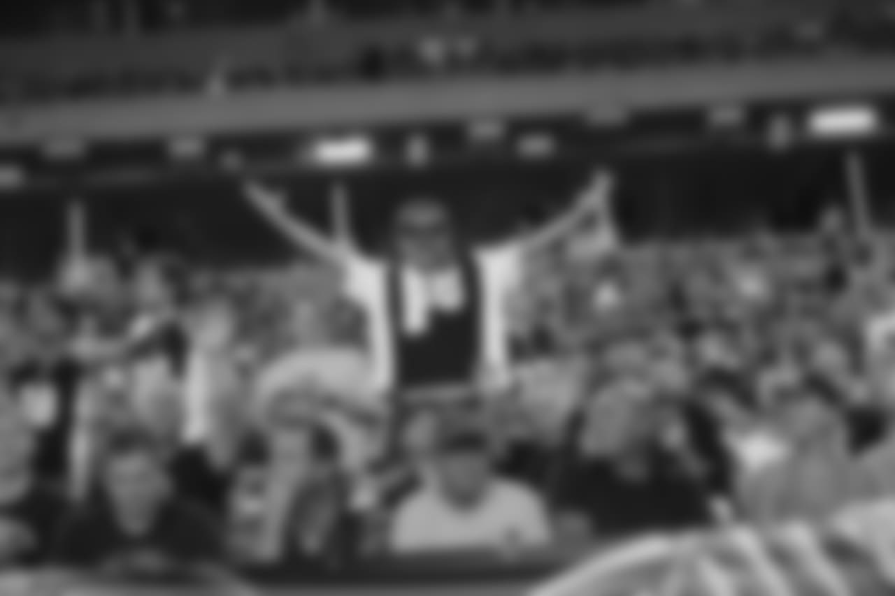 A Bengals fan stretches his arms during a game against the Baltimore Ravens.