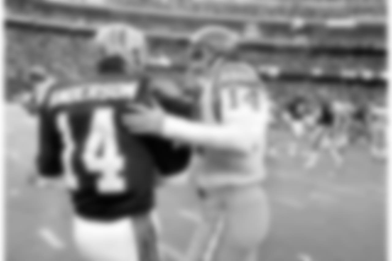 Cincinnati Bengals quarterback Ken Anderson, left, reacts as San Diego Chargers quarterback Dan Fouts, right, looks dejected after the Bengals defeated the Chargers in the AFC championship in Cincinnati on Jan. 10, 1982. Fouts was intercepted twice in the game, and Anderson passed for two touchdowns and no interceptions. (AP Photo)