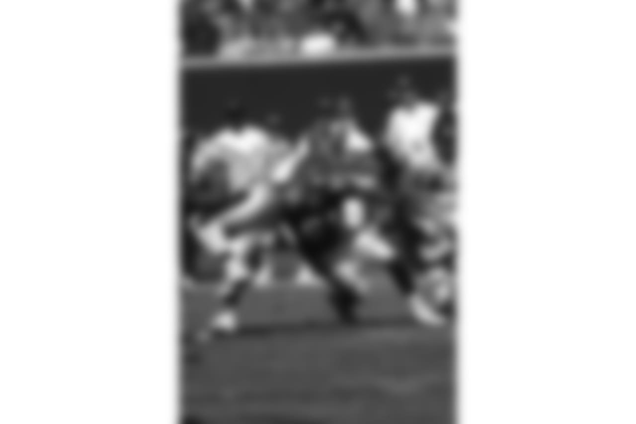 Kevin Hardy making a tackle during a 2003 game against Baltimore.