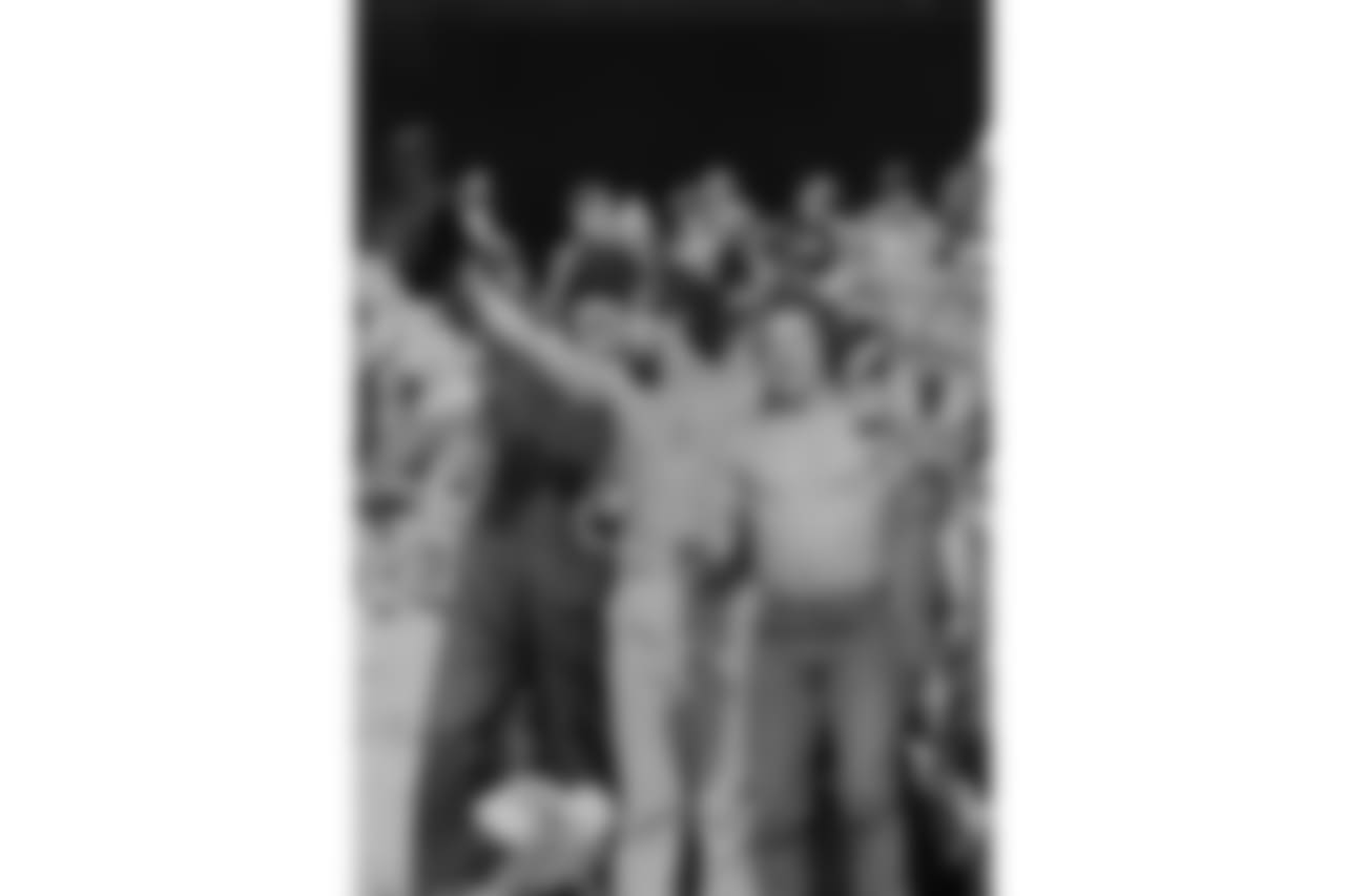 Shirtless Cincinnati Bengals fans are joined by another in a snowmobile suit as they cheer on the Bengals in the AFC championship game against the San Diego Chargers in Cincinnati, Jan. 10, 1982. Temperature at the game was minus 9 degrees. (AP Photo)