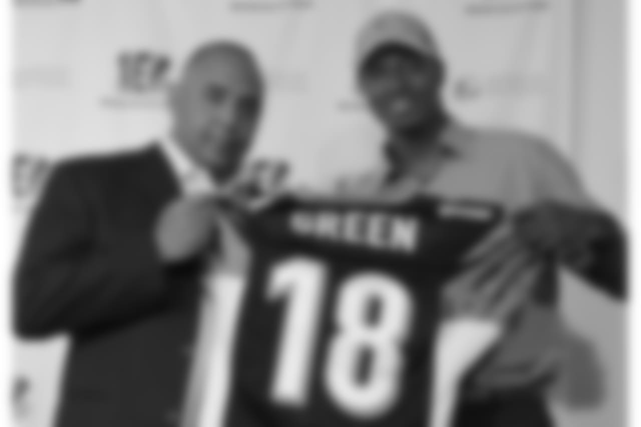 Bengals head coach Marvin Lewis holds up a jersey with first round pick A.J. Green at an introductory press conference in April.