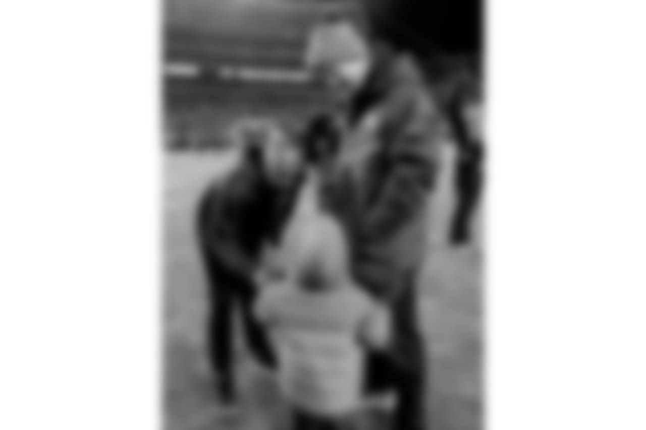 Denver Broncos quarterback Peyton Manning and his son, Marshall Manning, greet Cincinnati Bengals head coach Marvin Lewis prior to an NFL football game, Monday, Dec. 28, 2015, in Denver. (AP Photo/Jack Dempsey)