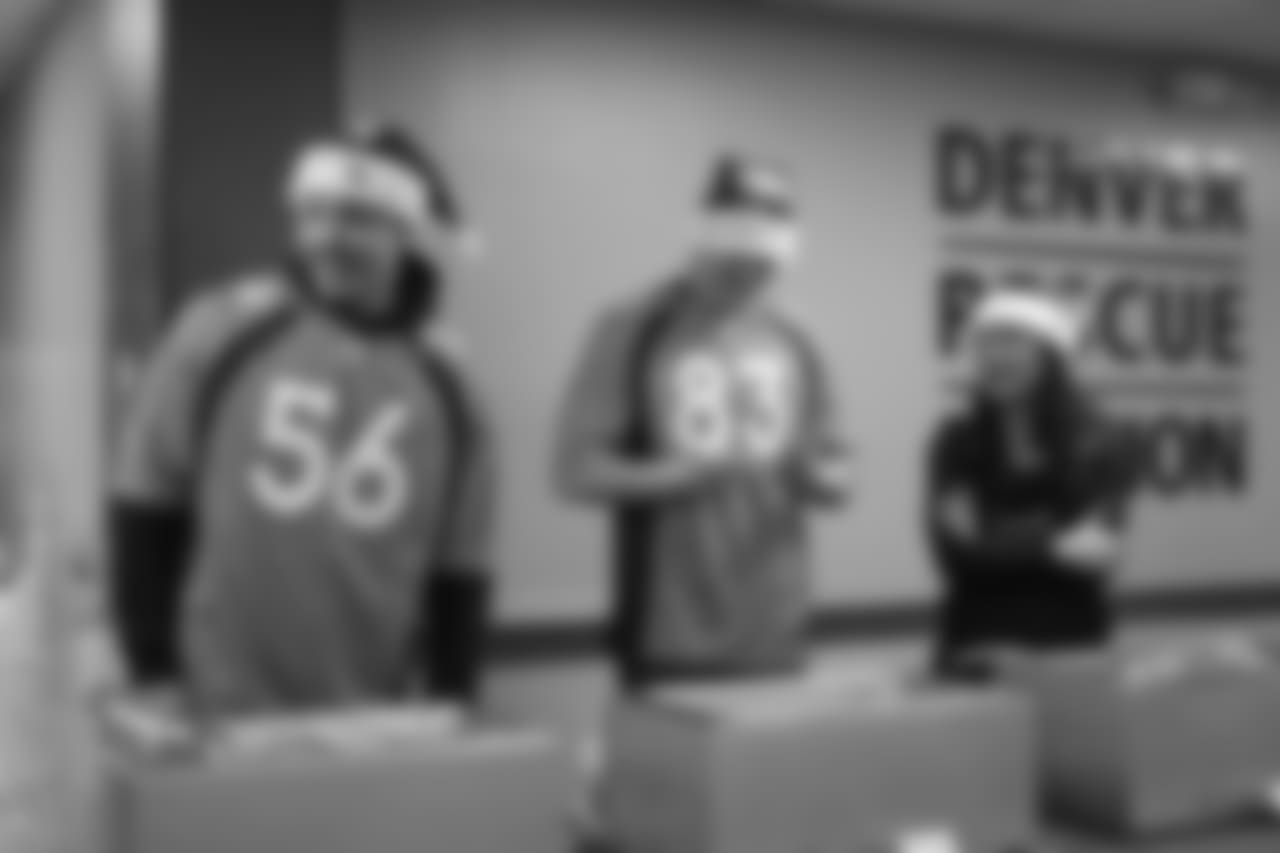 Shane Ray and Matt LaCosse serve dinner at the Denver Rescue Mission's 19th annual holiday party.