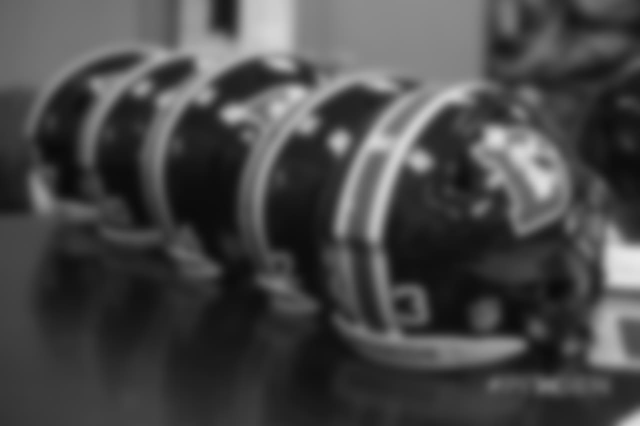 Inside the Broncos' equipment room as staffers transition helmets to the team's Color Rush set, applying new decals and throwback logos for the team's Week 12 game.