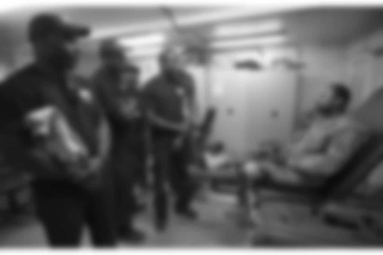 (l-r) Cleveland Browns linebacker DÕQwell Jackson, Denver Broncos linebacker Von Miller, Carolina Panthers wide receiver Steve Smith, Denver Broncos cornerback Champ Bailey, and Houston Texans defensive end J.J. Watt talk with an injured soldier stationed in the Middle East during a USO/NFL tour stop on March 18, 2013. This was the first USO tour for each player. USO Photo by Fred Greaves