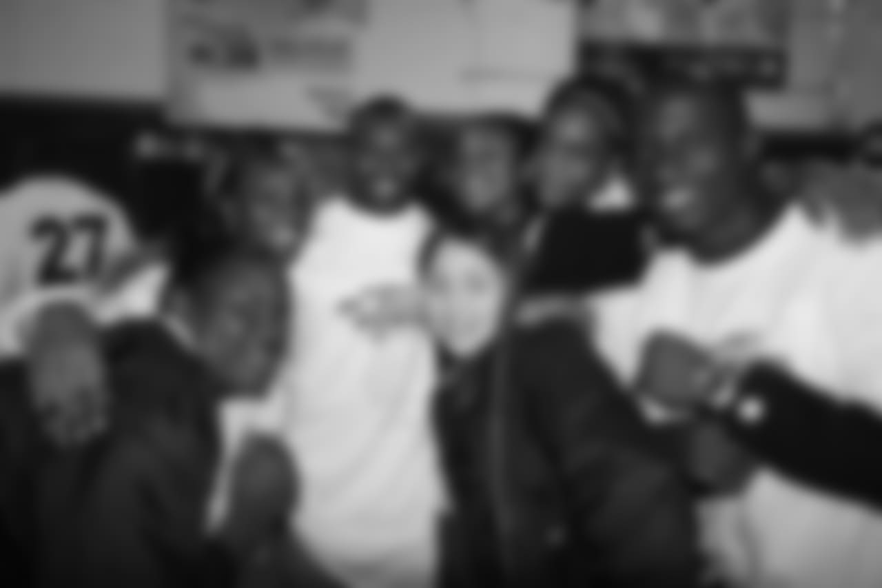 Andre Hall and Karl Paymah take a group photo at the ceremony for the grand opening of the Darrent Williams Memorial Teen Center at the Denver Broncos Boys & Girls Club in 2007.