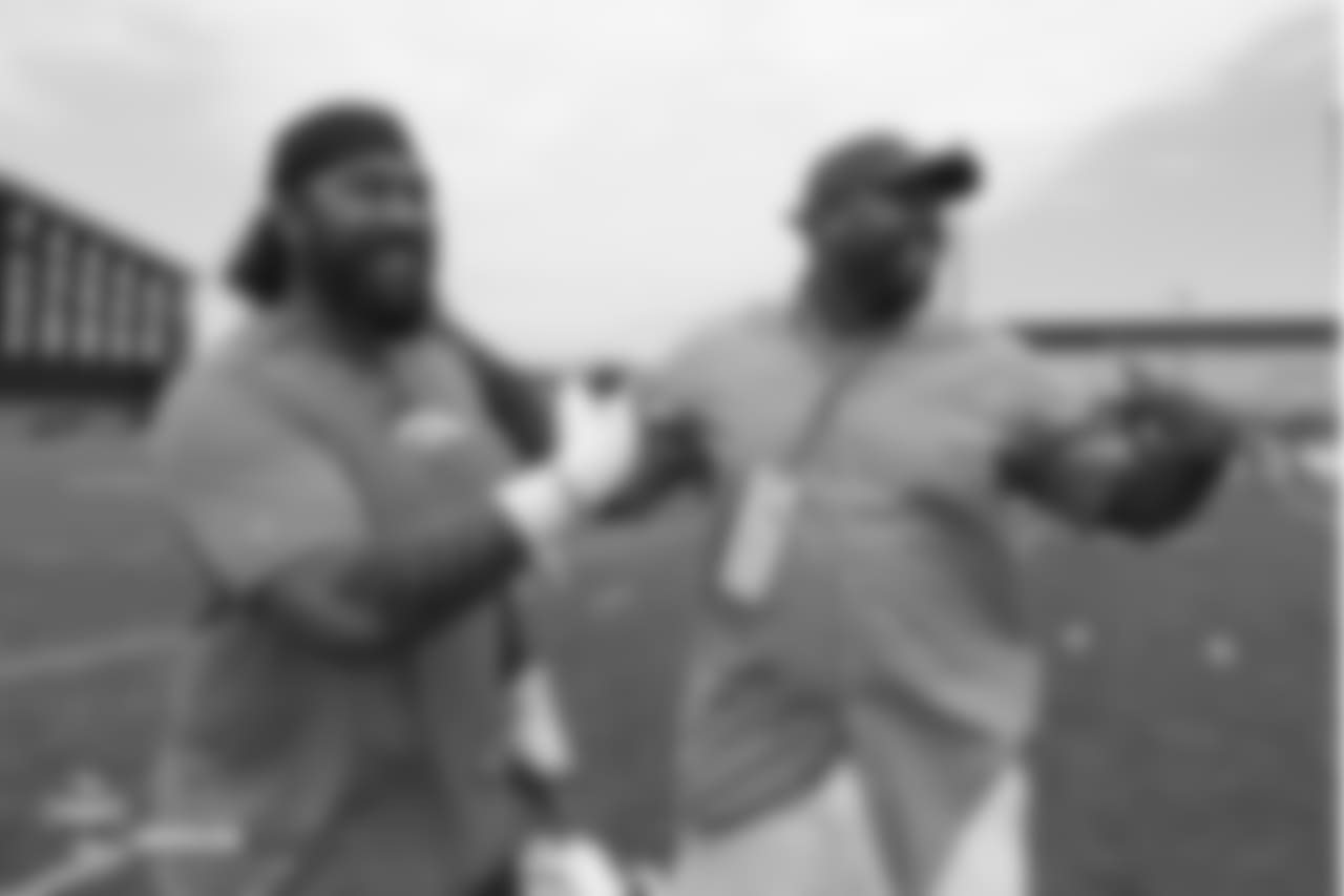 Nose tackle Domata Peko Sr. (94) points to former Bronco Kevin Vickerson as he does the same to him during the 10th day of training camp on August 8, 2018, at UCHealth Training Center. The two were college teammates.