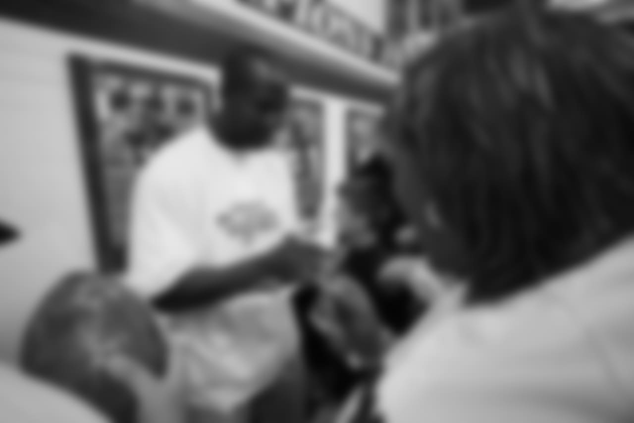 Champ Bailey signs autographs at the ceremony for the grand opening of the Darrent Williams Memorial Teen Center at the Denver Broncos Boys & Girls Club in 2007.