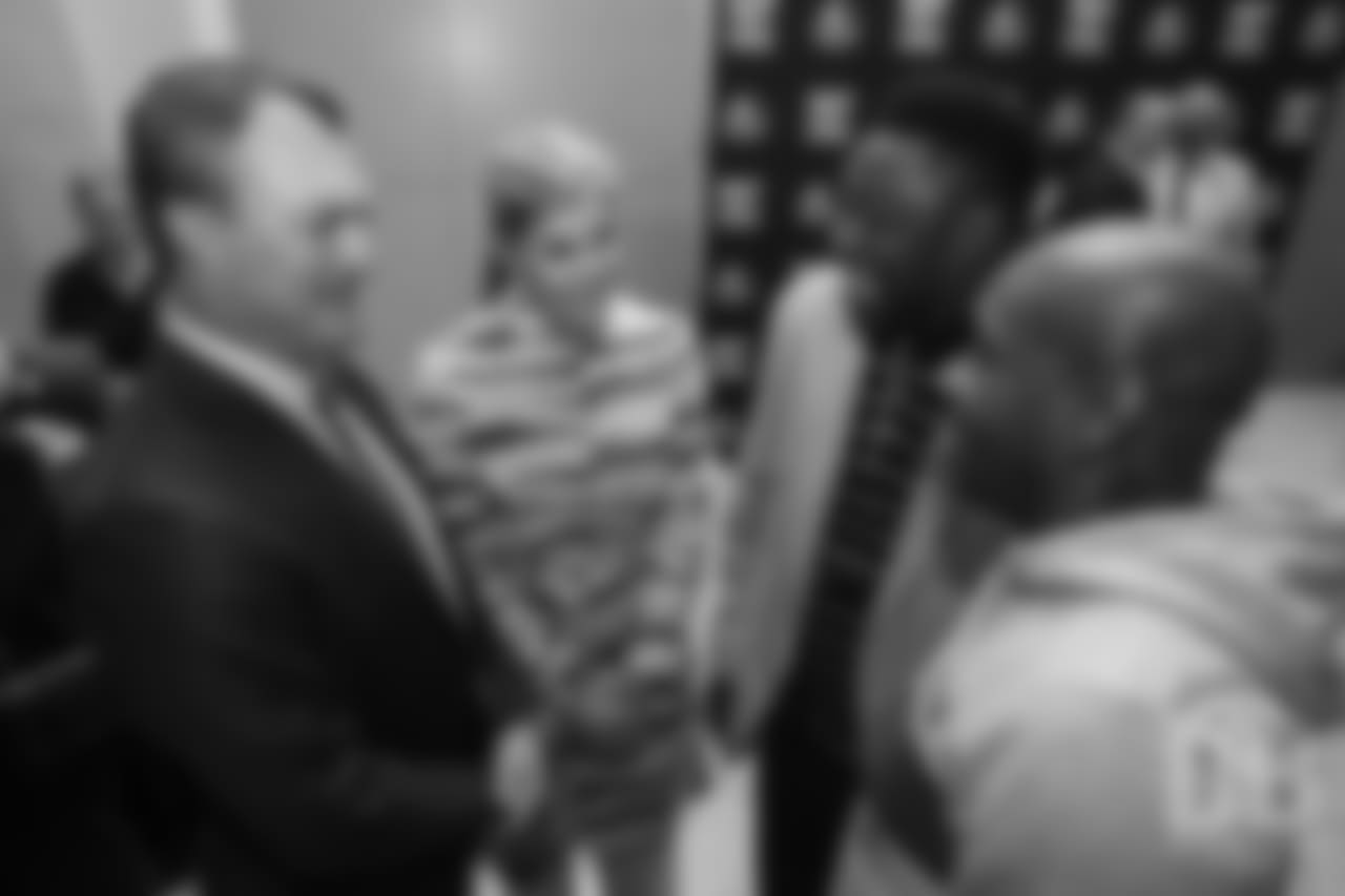 John Lynch greets Warren Sapp at the Pro Football Hall of Fame's Merlin Olsen Luncheon in Atlanta on February 1, 2019.