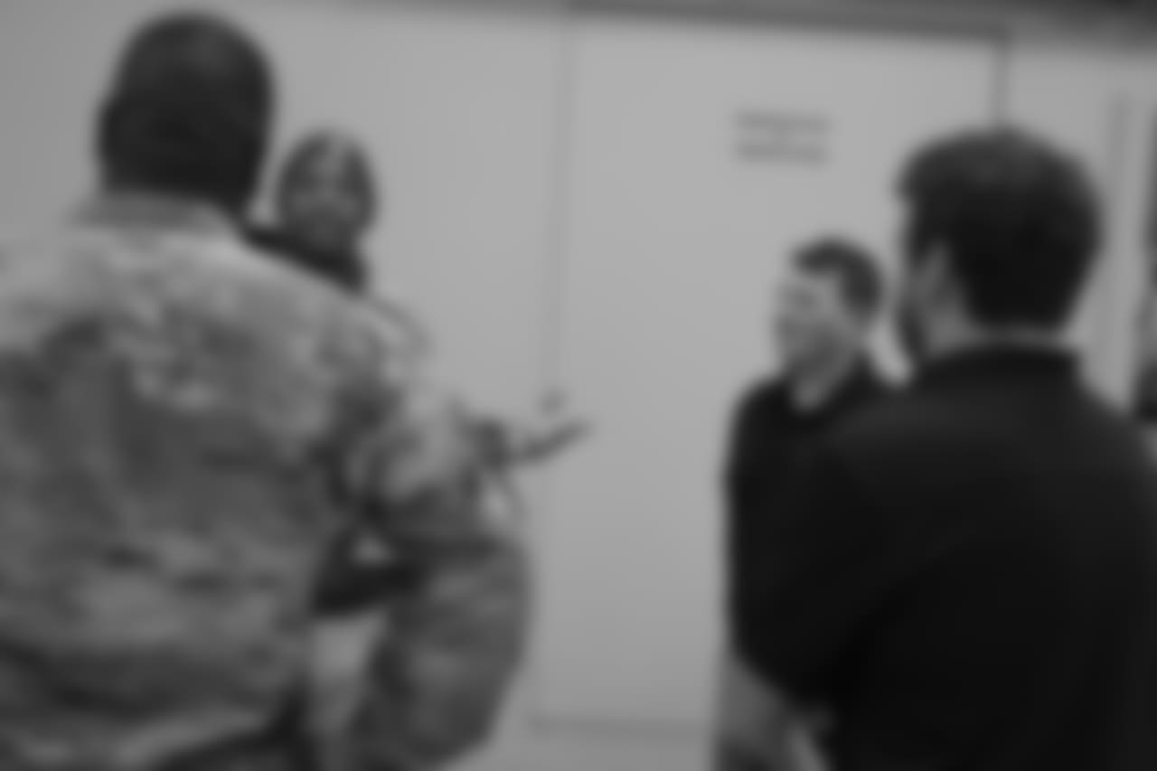 DeMarcus Walker talks with military members during the Denver Broncos' Salute To Service Caravan at Fort Carson, Colorado on October 30, 2018.