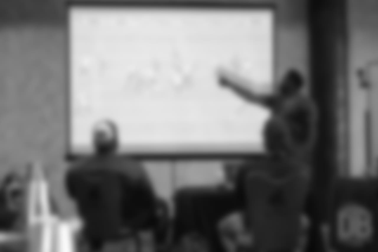Warren Sapp reviews player film at Von Miller's Pass Rush Summit, which included hands-on instruction and drills, on June 28, 2018.