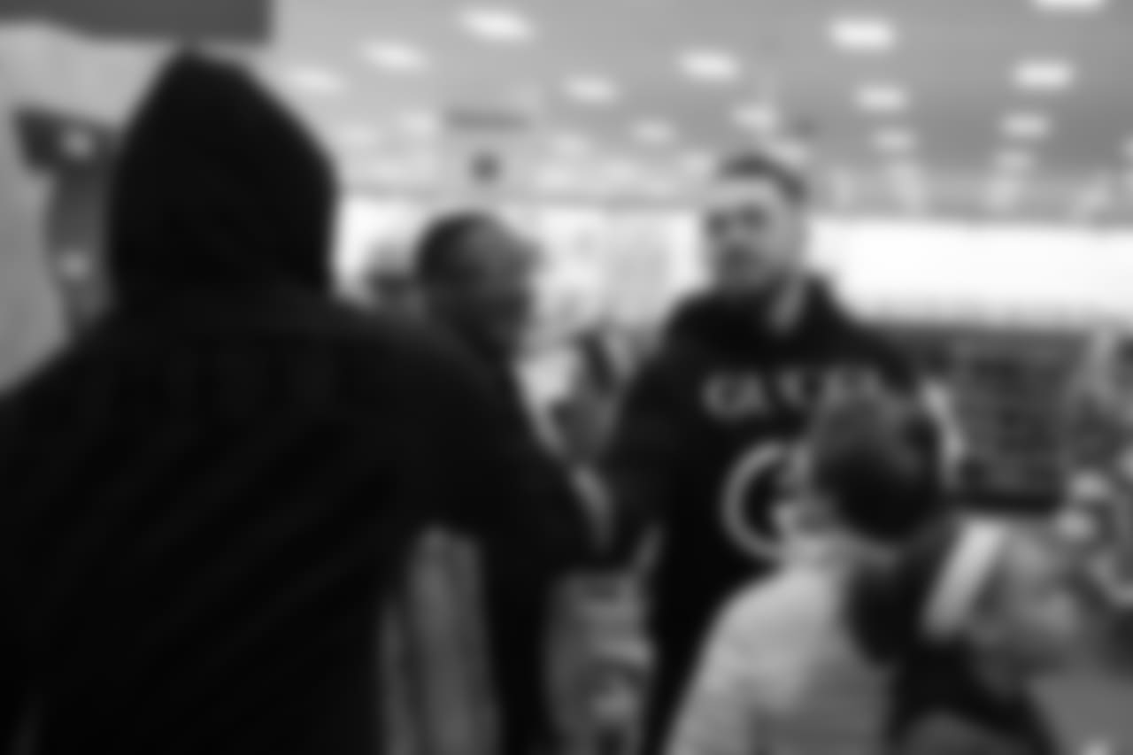 Derek Wolfe shakes Von Miller's hand during Will Parks' shopping spree for the Boys & Girls Club of Metro Denver on Dec. 3, 2018