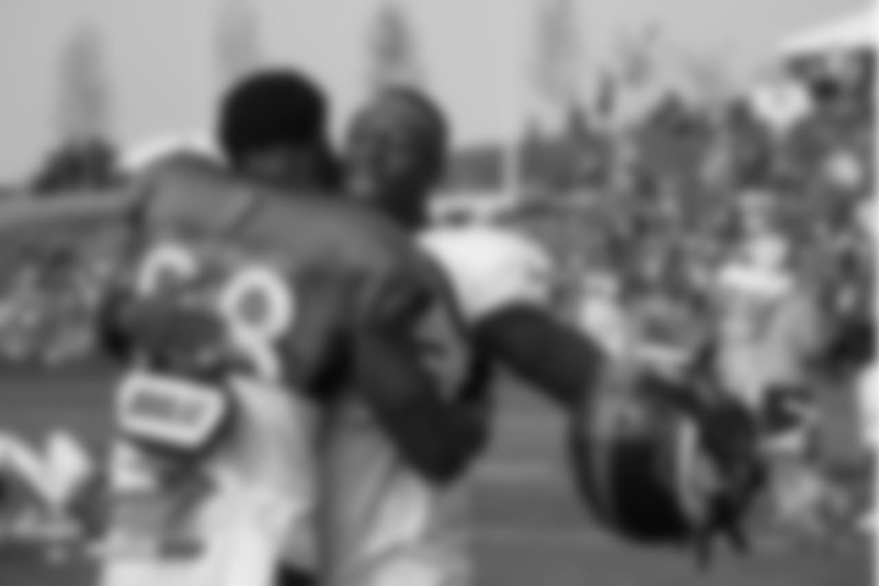 Wide receiver Demaryius Thomas (88) hugs safety Will Parks (34) at the fifth day of training camp on August 1, 2018, at UCHealth Training Center.