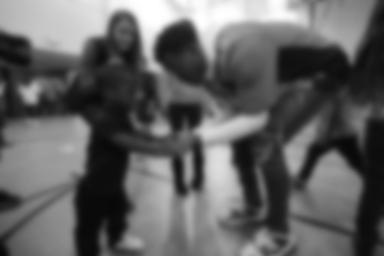 Demaryius Thomas gives a high-five at a Playworks recess visit (alongside CarMax volunteers) with first-, second- and third-grade students at Greenwood Academy on October 9, 2018.