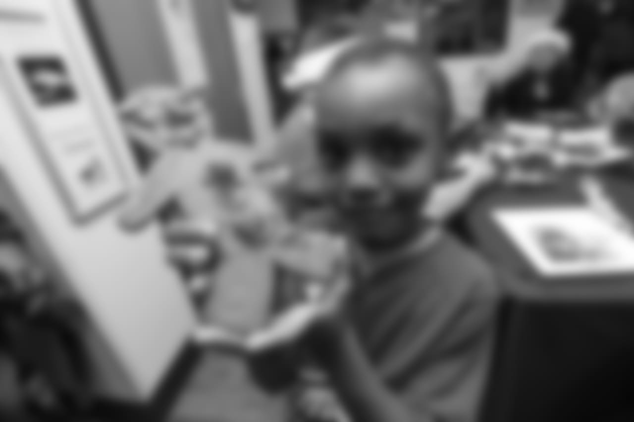 A young boy shows off his decorated gingerbread cookie at the Denver Rescue Mission's 19th annual holiday party.