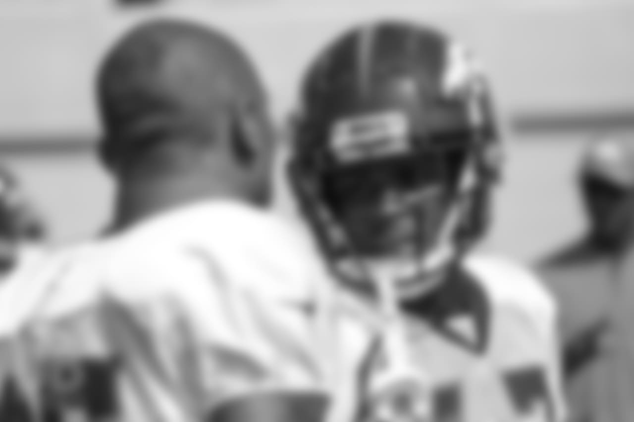 Cornerback C.J. Smith (28) talks with cornerback Chris Harris Jr. (25) during a practice at UCHealth Training Center on Aug. 13, 2018.