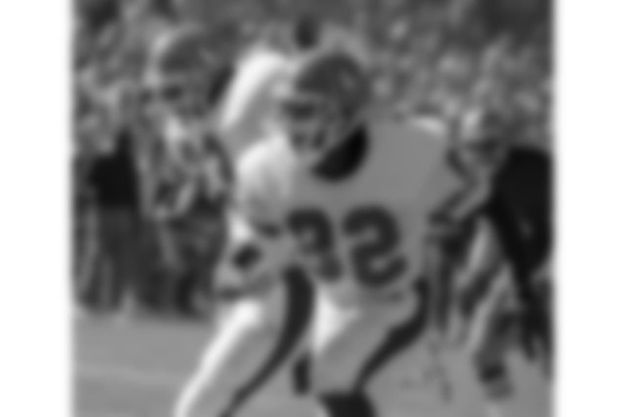 Denver Broncos wide receiver Vance Johnson (82) blocks for running back Sammy Winder (23).