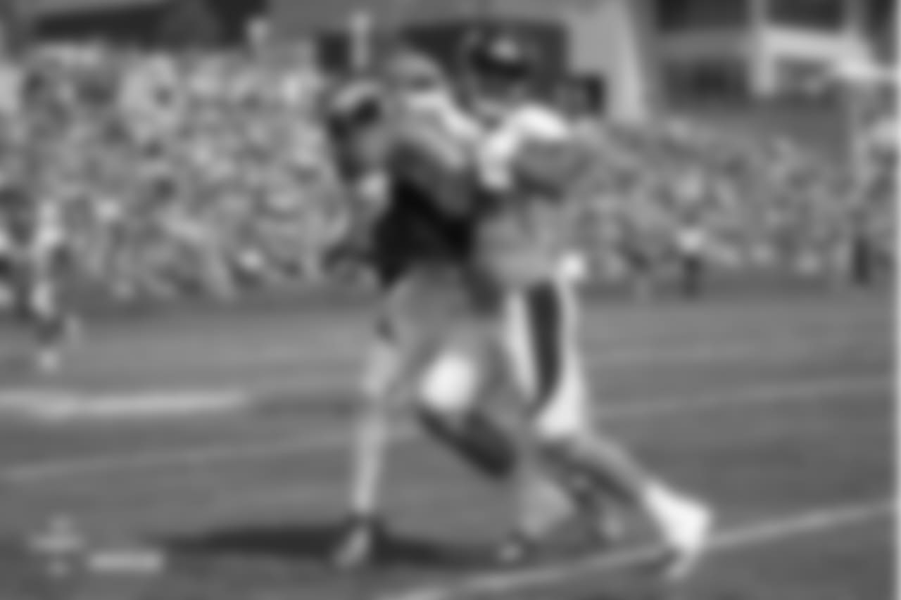 Cornerback Marcus Rios (38) wraps up wide receiver River Cracraft (15) during the ninth day of training camp on August 7, 2018, at UCHealth Training Center.