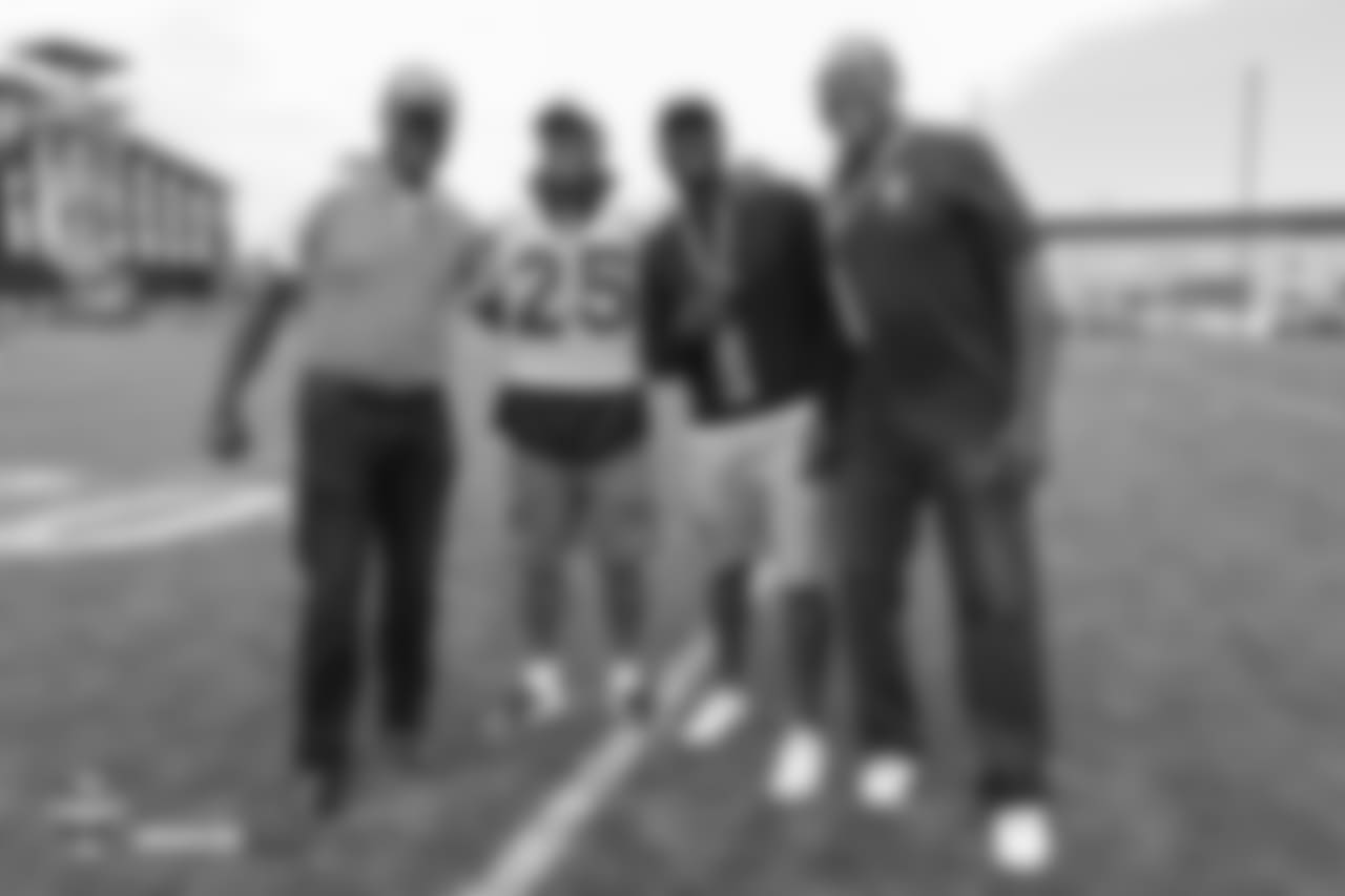 Cornerback Chris Harris Jr. (25) with Ring of Fame former safety Billy Thompson and other Broncos alumni during the 10th day of training camp on August 8, 2018, at UCHealth Training Center.