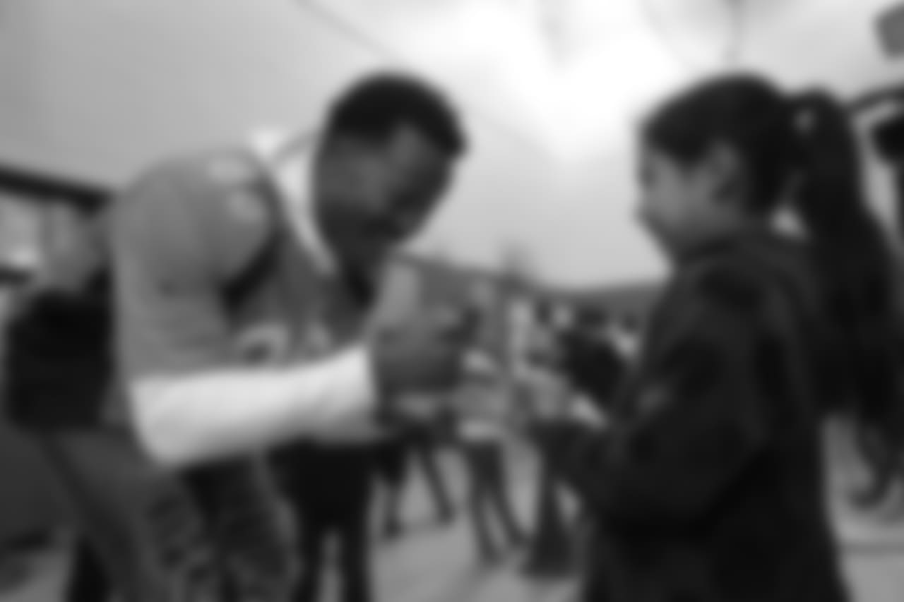Demaryius Thomas plays rock, paper, scissors at a Playworks recess visit (alongside CarMax volunteers) with first-, second- and third-grade students at Greenwood Academy on October 9, 2018.