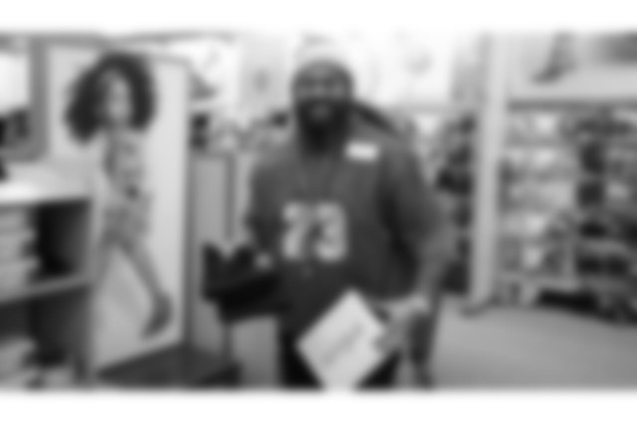 Domata Peko Sr. picks out some boots during Will Parks' shopping spree for the Boys & Girls Club of Metro Denver on Dec. 3, 2018