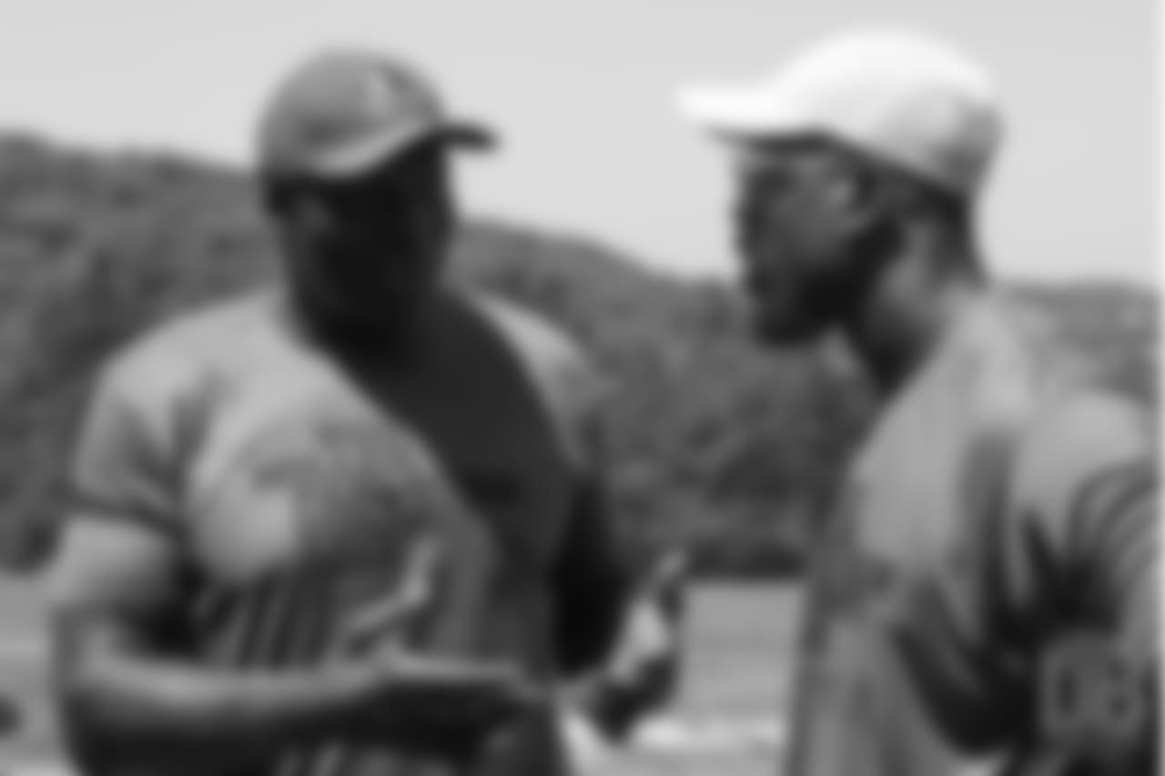 Bruce Smith talks with Von Miller during the on-field portion of Von Miller's Pass Rush Summit, which included hands-on instruction and drills, on June 28, 2018.