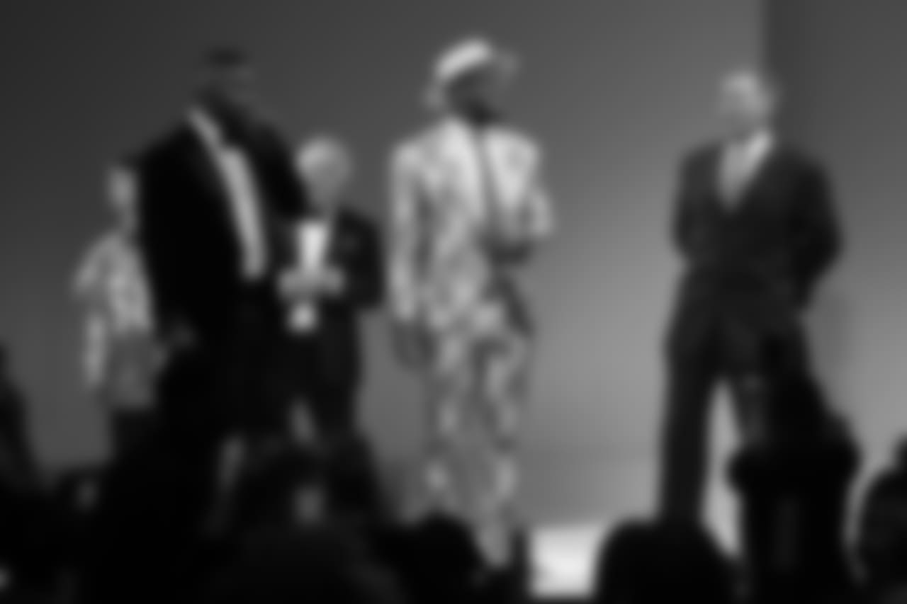 Von Miller onstage with actors John C. McGinley and Jamie Foxx as Foxx auctions off Miller's jacket at the Global Down Syndrome Foundation's Be Beautiful Be Yourself Fashion Show at the Sheraton Denver Downtown on October 20, 2018.