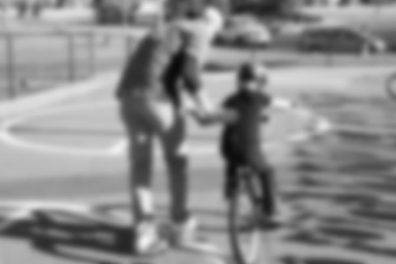 Tim Semisch helps a bike rider during a bike distribution at Green Valley Elementary School in Denver on December 18, 2018.