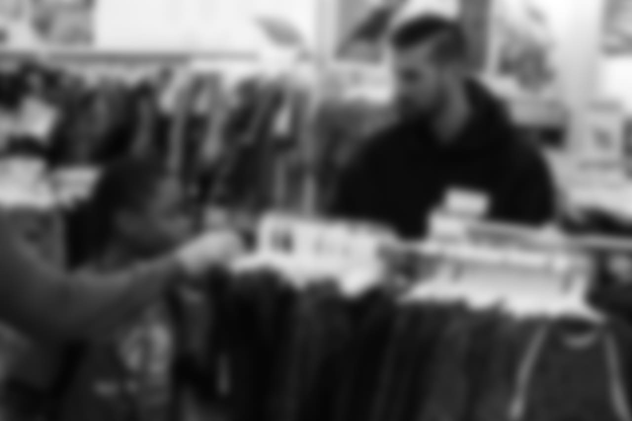 Brandon McManus helps a participant choose clothes during Will Parks' shopping spree for the Boys & Girls Club of Metro Denver on Dec. 3, 2018