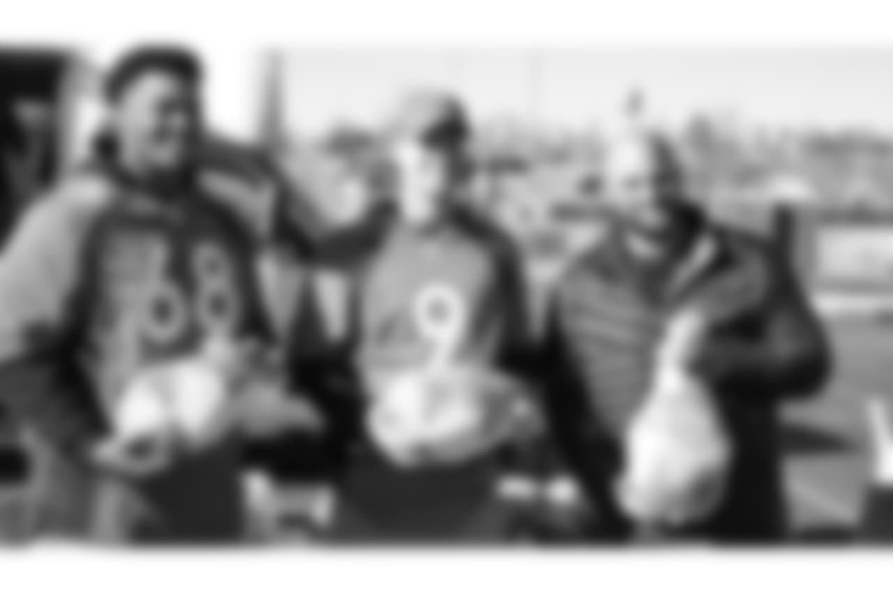 (From left) Elijah Wilkinson, Kevin Hogan and Gino Gradkowski during the Denver Rescue Mission's Thanksgiving Turkey in a Box distribution on Nov. 20, 2018