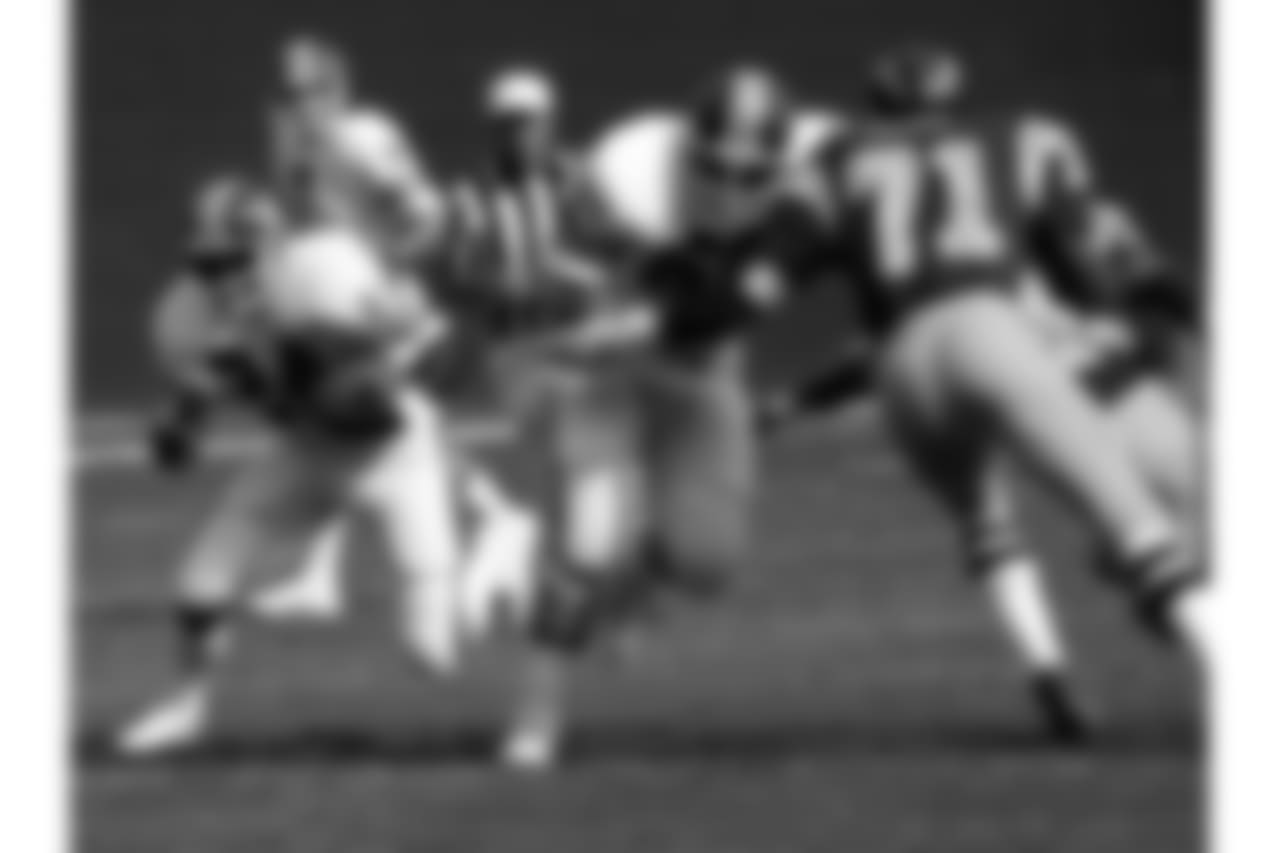 Running back Otis Armstrong (24) runs upfield behind guard Paul Howard (60) during an NFL game against the San Diego Chargers in San Diego, Nov. 13, 1977. The Broncos defeated the Chargers 17-14. (AP Photo/NFL Photos)