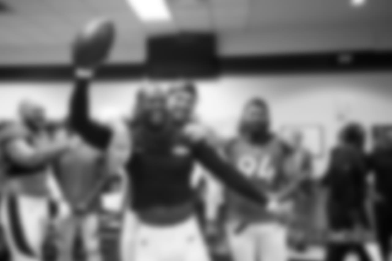 Von Miller and Derek Wolfe celebrate with the game ball after the Broncos' 27-24 win over the Seahawks to start the season.