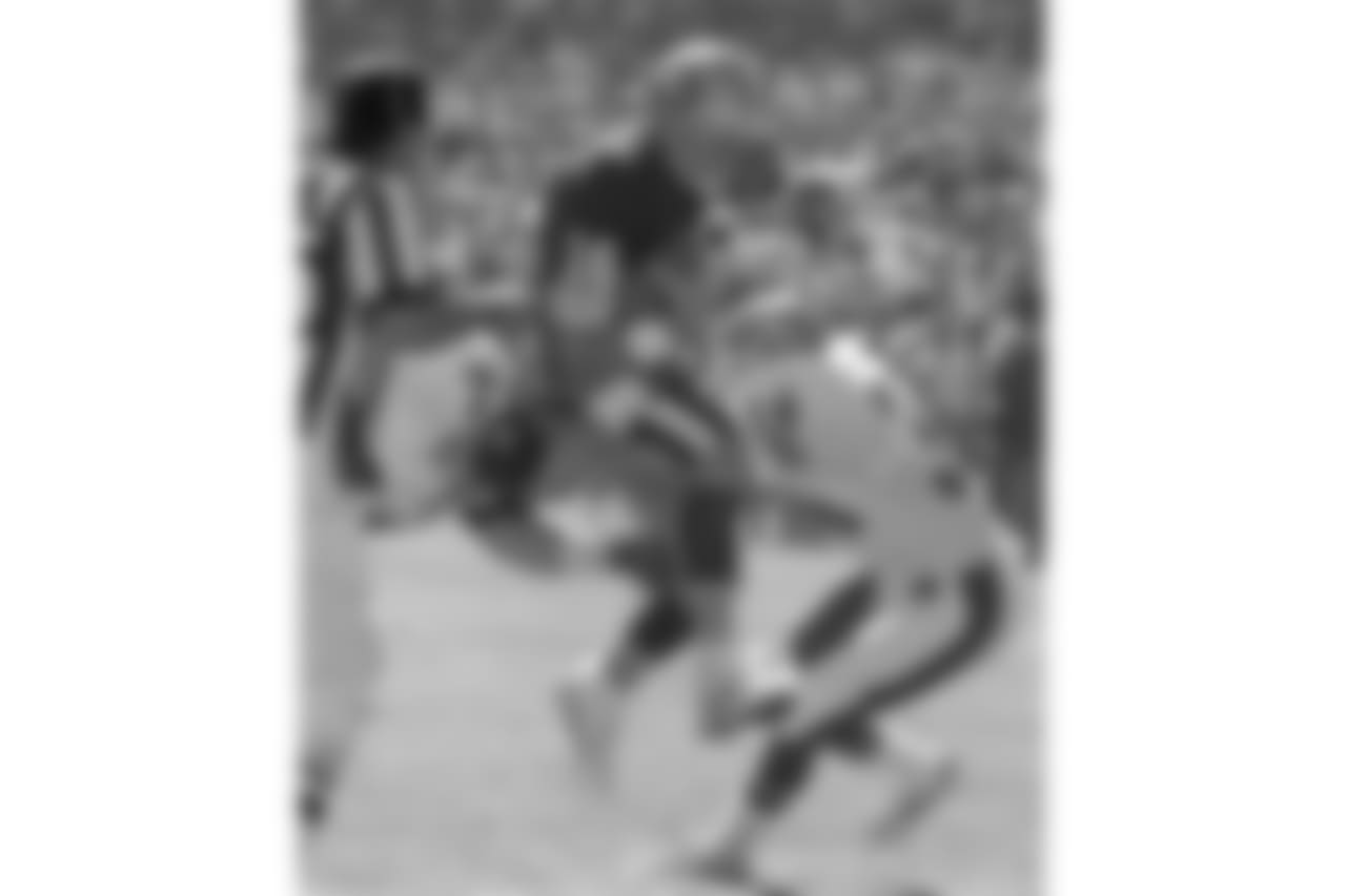 Broncos defensive end Greg Kragen (71) and defensive back Tyrone Braxton (34) stop San Francisco quarterback Joe Montana (16).