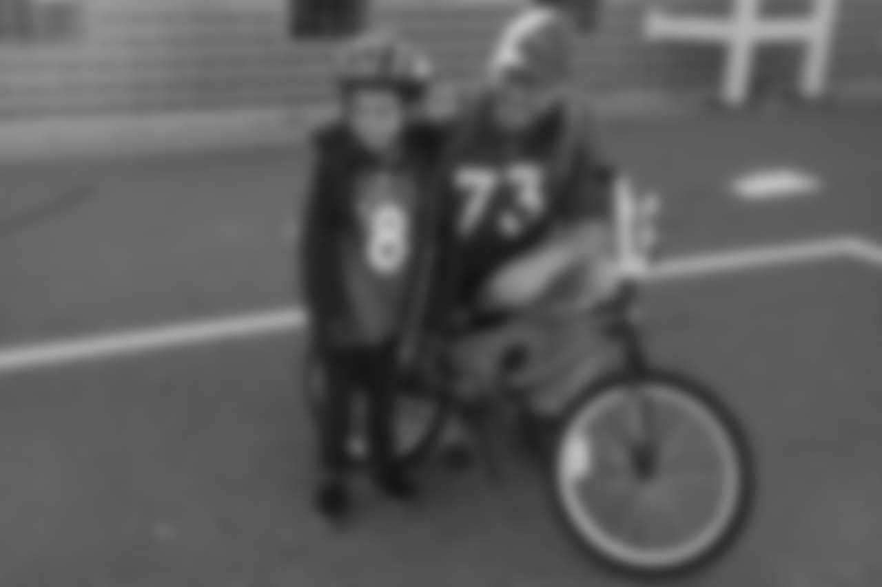 Andreas Knappe and a bike recipient during a bike distribution at Green Valley Elementary School in Denver on December 18, 2018.