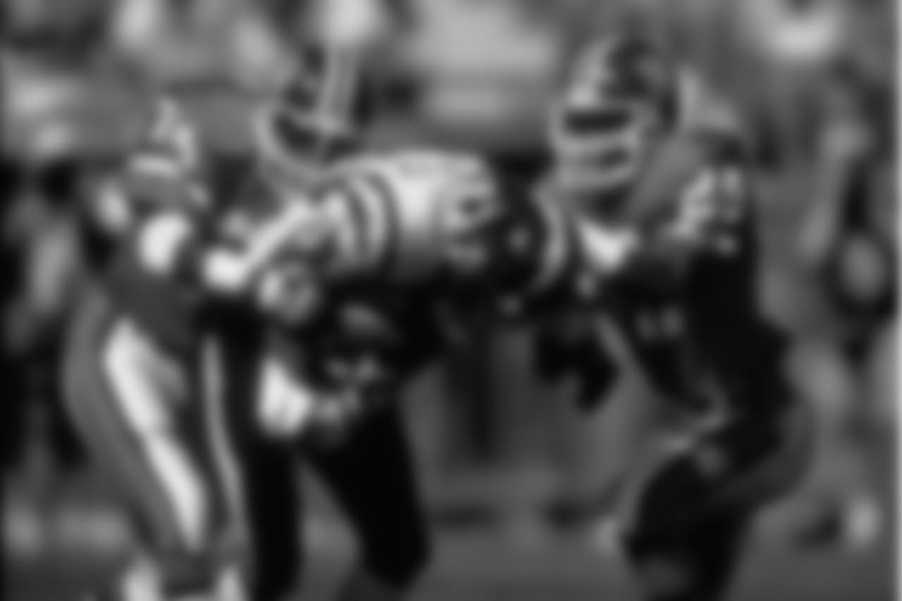 Safety Tyrone Braxton and cornerback Charles Dimry tackle a Charger in a September 13, 1992 win (21-13) over San Diego.