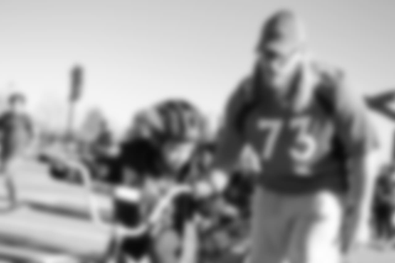 Andreas Knappe helps a bike rider during a bike distribution at Green Valley Elementary School in Denver on December 18, 2018.