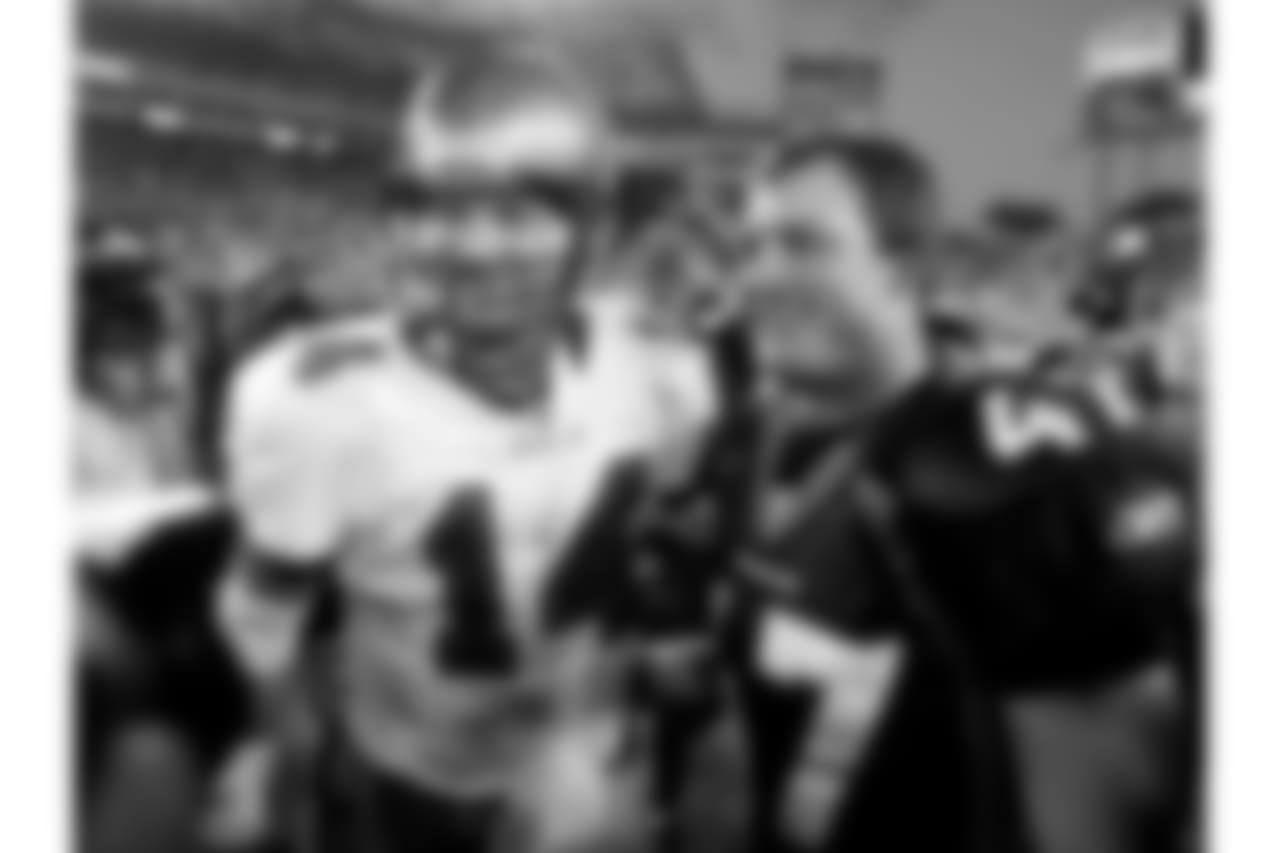 Tampa Bay Buccaneers quarterback Brad Johnson, left, greets his former teammate now with the Denver Broncos John Lynch, right, following the Broncos 16-13 victory over the Buccaneers on Sunday, October 3, 2004 in Tampa, Fla. (AP Photo/Scott Audette)