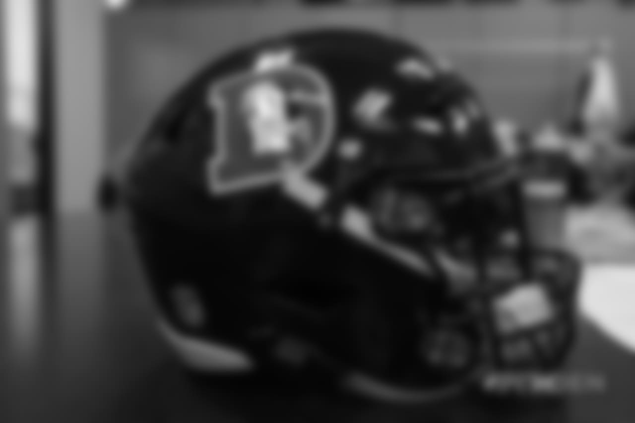 Inside the Broncos' equipment room as staffers transition helmets to the team's Color Rush set, applying new decals and throwback logos for the team's Week 12 game.