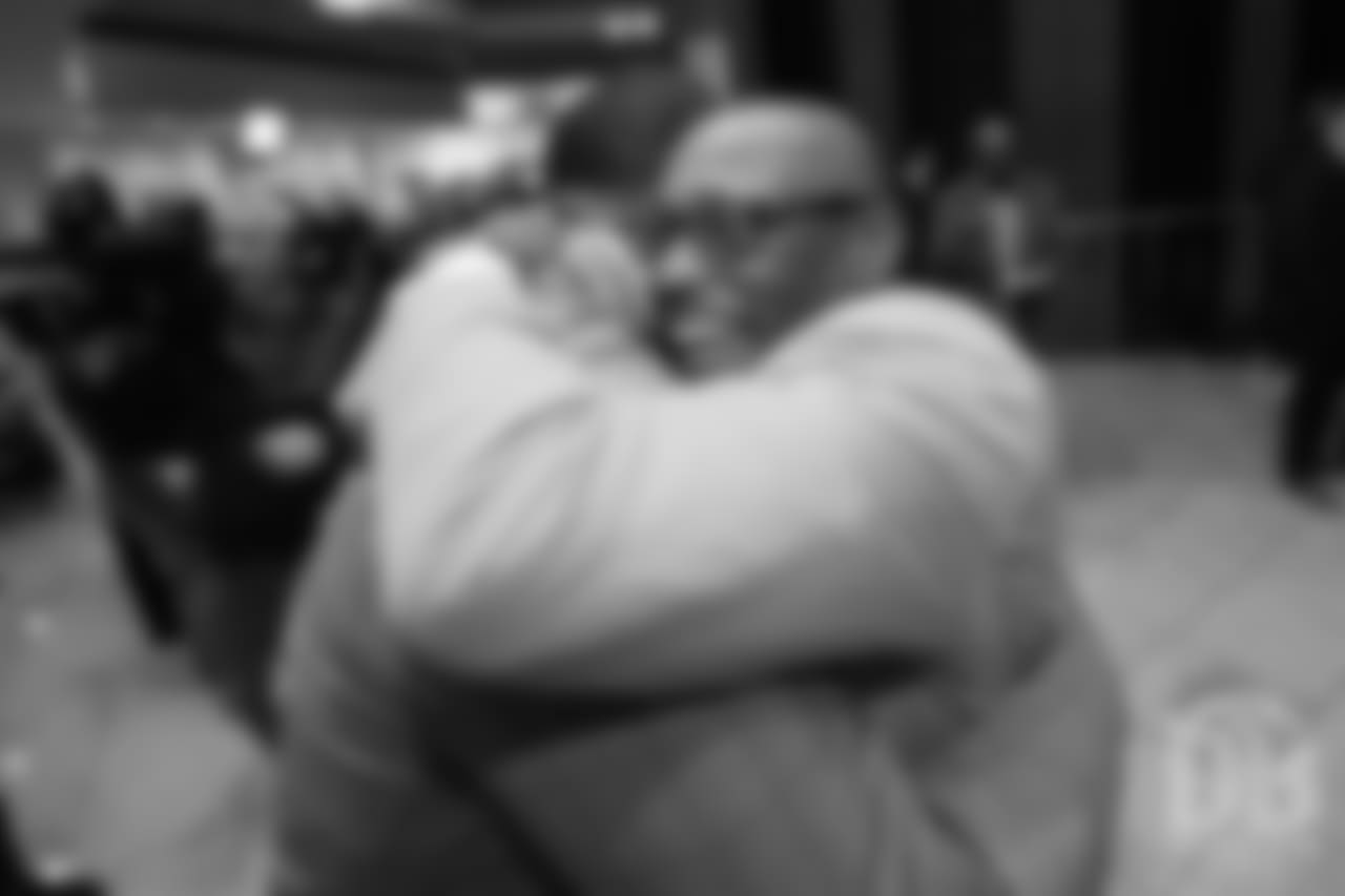 Floyd Little hugs Steve Atwater at the Pro Football Hall of Fame's Merlin Olsen Luncheon in Atlanta on February 1, 2019.