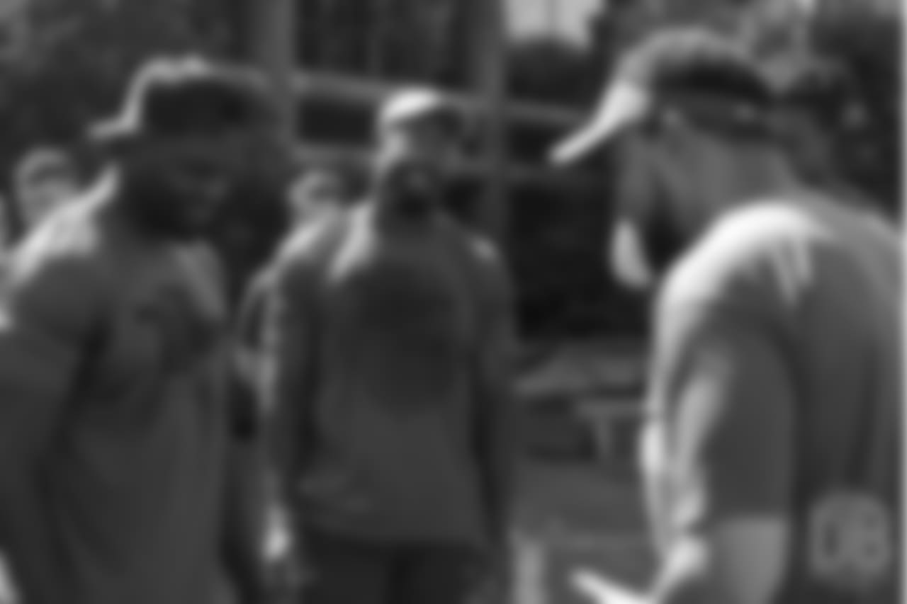 Von Miller watches Shaquil Barrett and pass rush coach Chuck Smith during the the on-field portion of Von Miller's Pass Rush Summit, which included hands-on instruction and drills, on June 28, 2018.