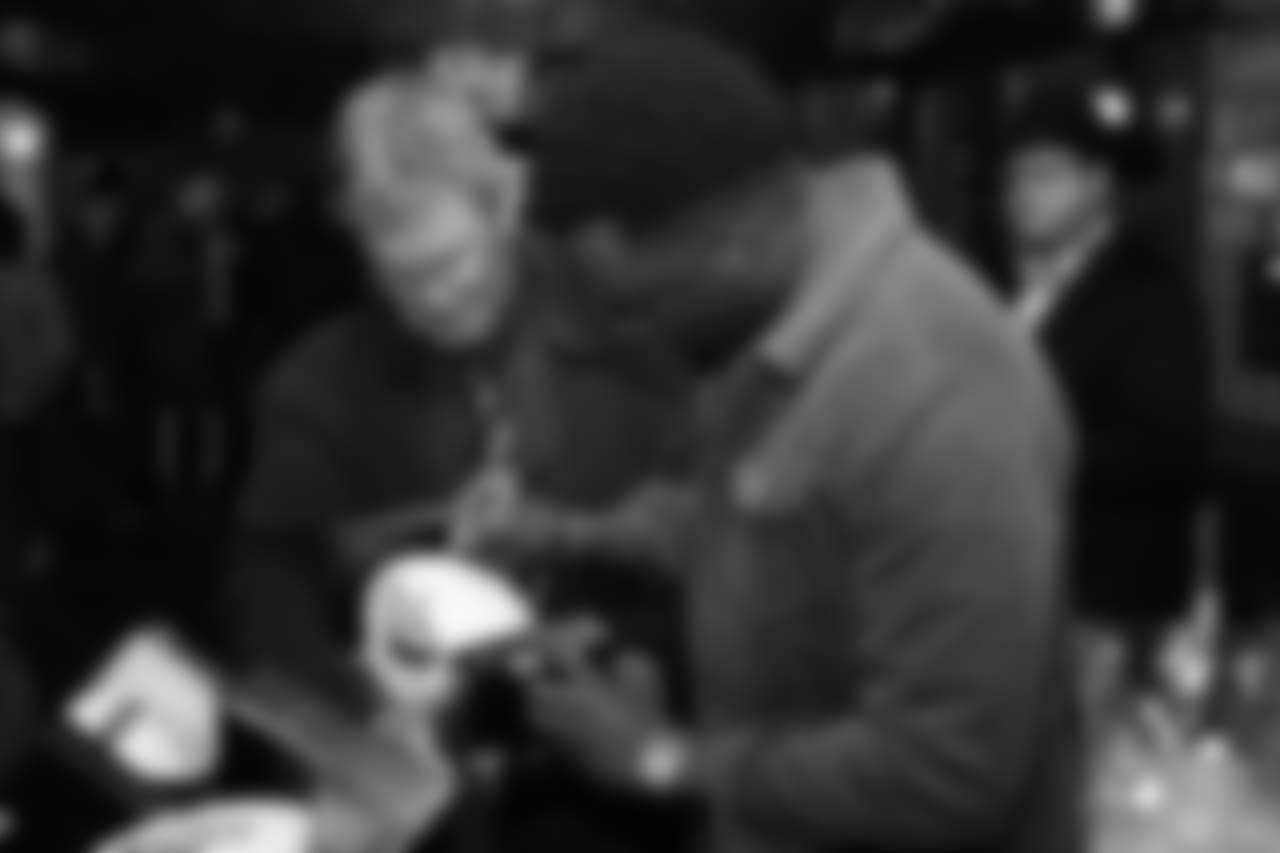 Brandon Marshall signs a football during Von's Vision at Mile High Station in Denver on November 5, 2018.