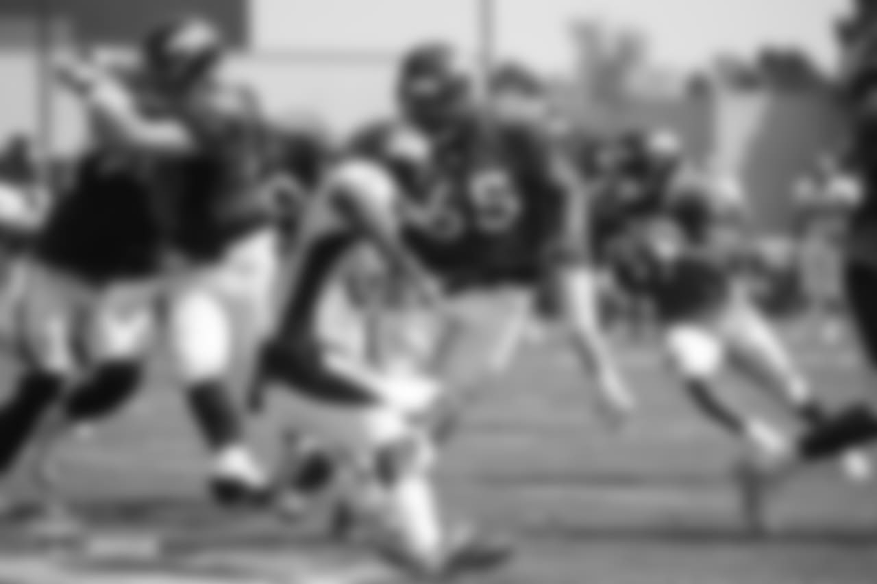 Guard Ron Leary (65) prepares to block for running back Royce Freeman (37) during the ninth day of training camp on August 7, 2018, at UCHealth Training Center.
