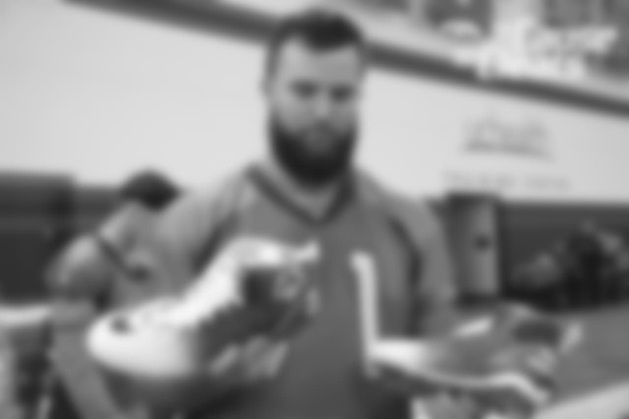 Austin Schlottmann shows off his custom cleats during the 2018 My Cause My Cleats unveiling for the players.