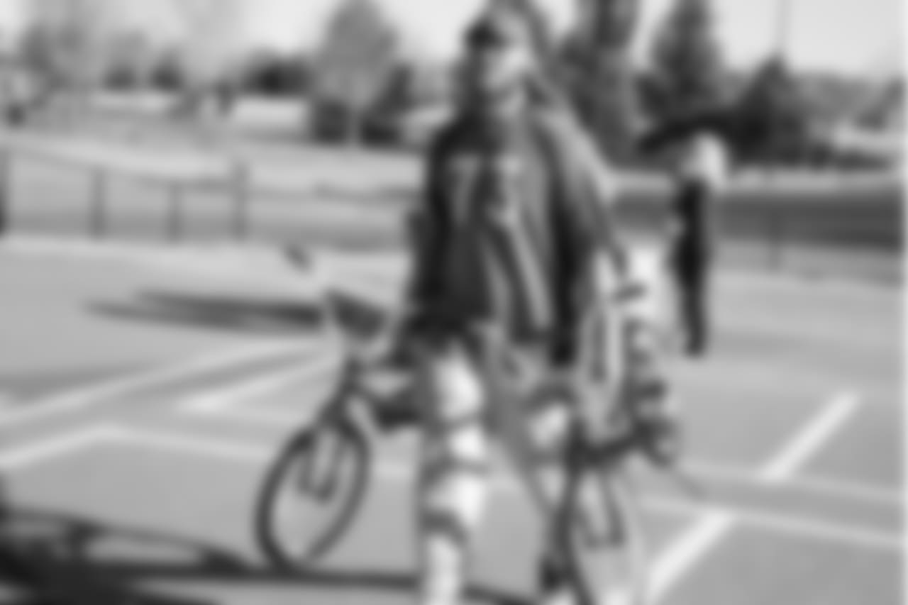 Andreas Knappe carries bikes during a bike distribution at Green Valley Elementary School in Denver on December 18, 2018.